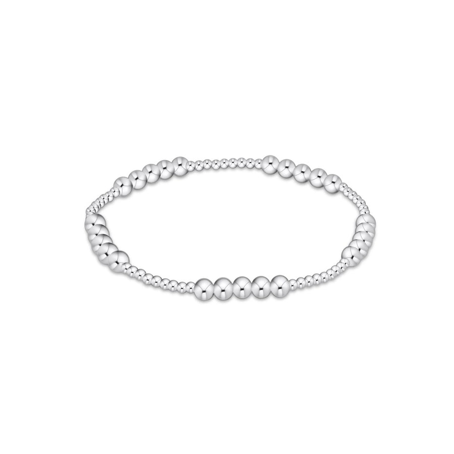 A silver beaded stretch bracelet featuring alternating smooth and textured round beads, displayed against a solid white background.