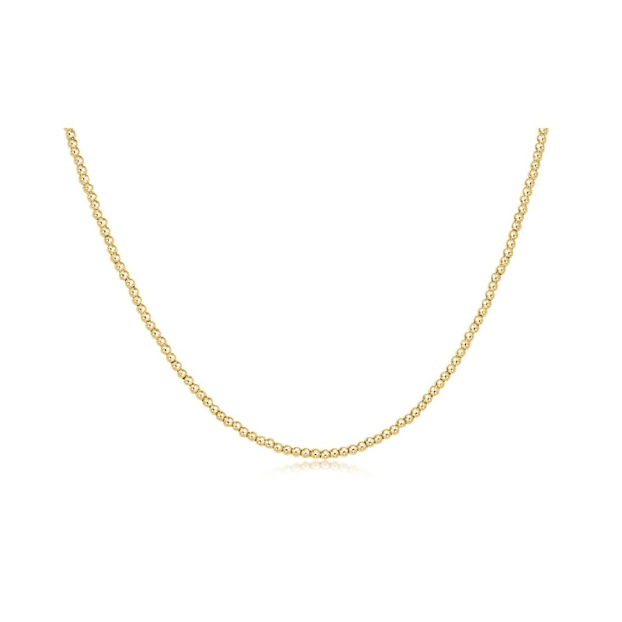 A delicate yellow gold chain necklace displayed in a U-shape against a solid white background.