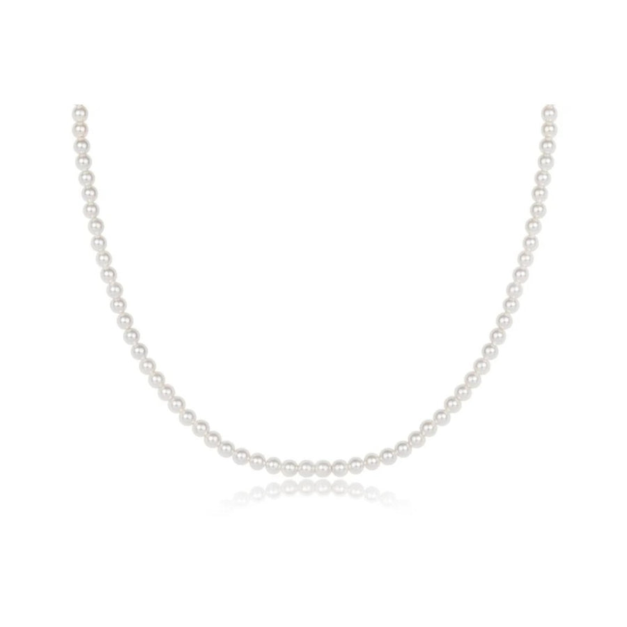 A classic white pearl necklace arranged in a neat U-shape on a clean white background with a subtle reflection below.