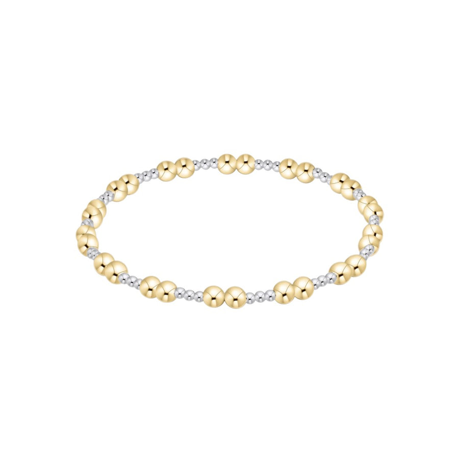 A two-tone beaded stretch bracelet featuring polished yellow gold and silver-toned beads, displayed on a clean white background.