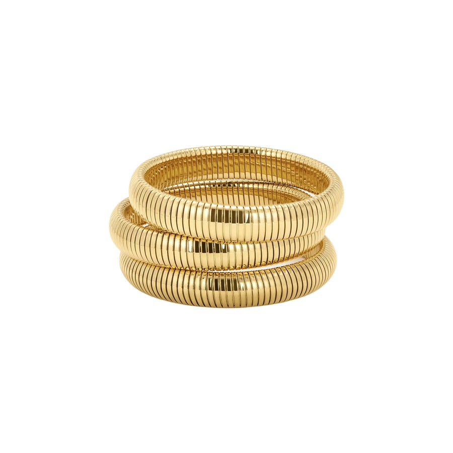 Gold ribbed bracelets on white background.