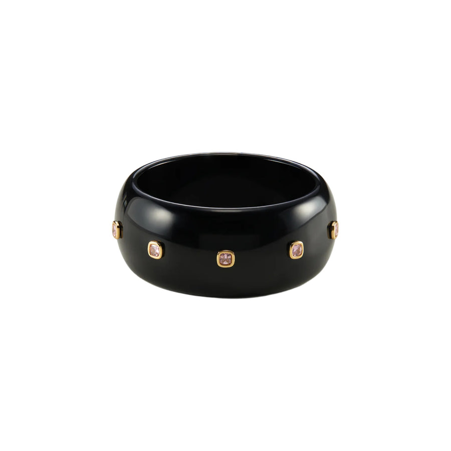 A glossy black ceramic bangle bracelet with five small gold-toned oval bezel-set stones, shown on a plain white background.