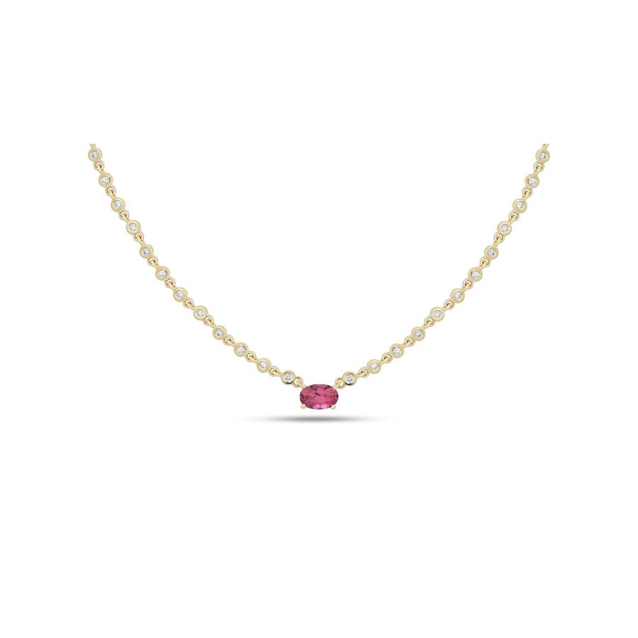 A delicate yellow gold chain necklace featuring a single oval-cut pink gemstone pendant, accented with small round clear stones along the chain, set against a plain white background.