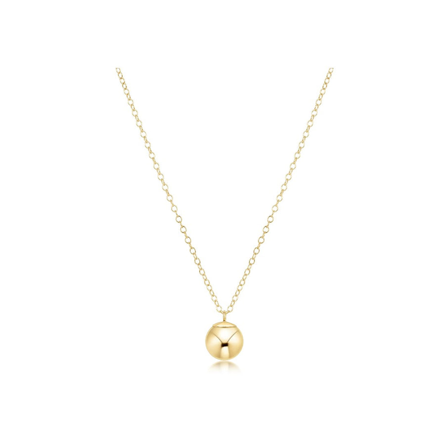 A delicate gold chain necklace with a polished spherical pendant featuring a vertical channel cut, displayed on a clean white background.