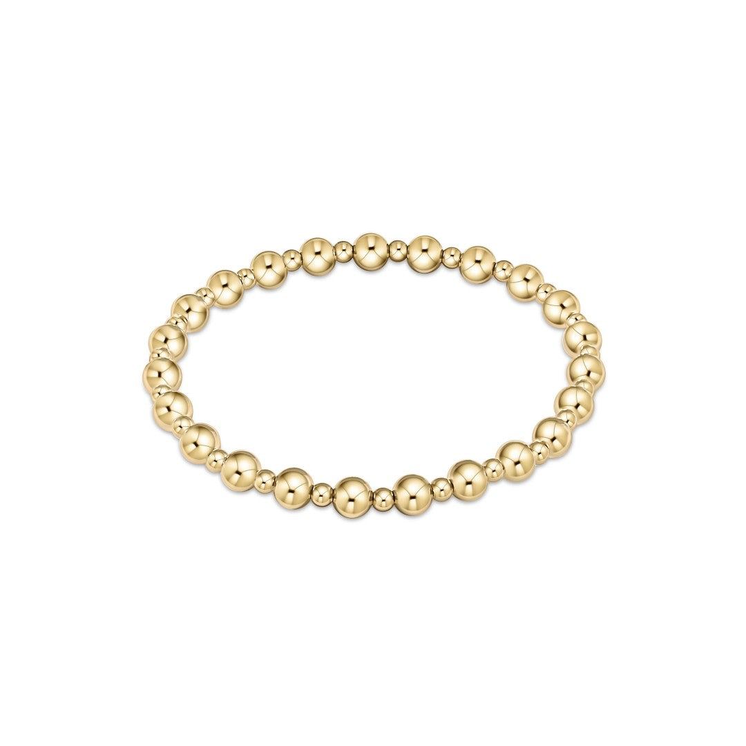 A gold beaded stretch bracelet with polished metallic round beads, displayed on a clean white background.