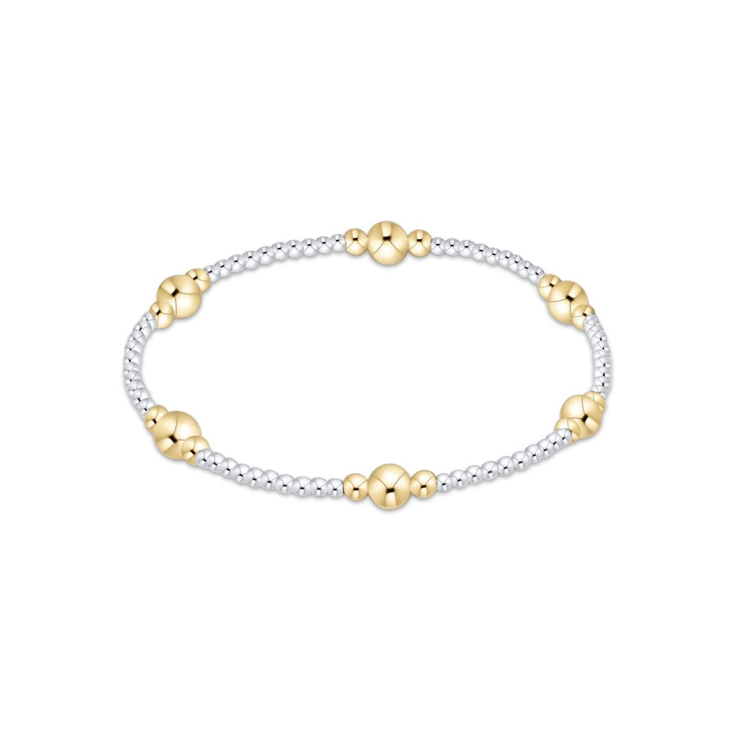A delicate two-tone beaded bracelet featuring polished yellow gold flower-shaped beads and silver-toned round beads, displayed on a clean white background.