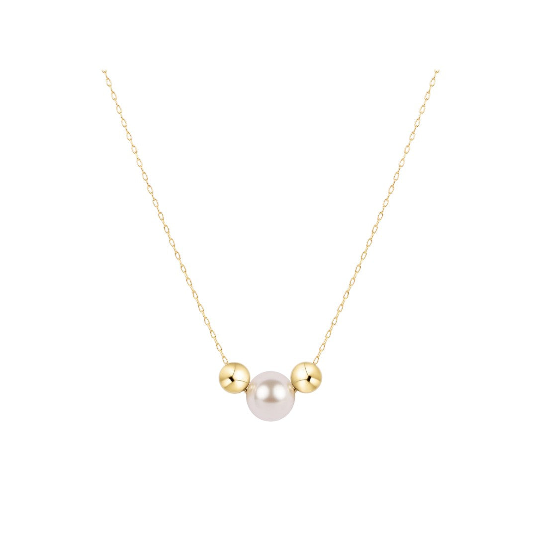 A delicate gold chain necklace featuring a central white pearl flanked by two small gold beads, presented on a clean white background.