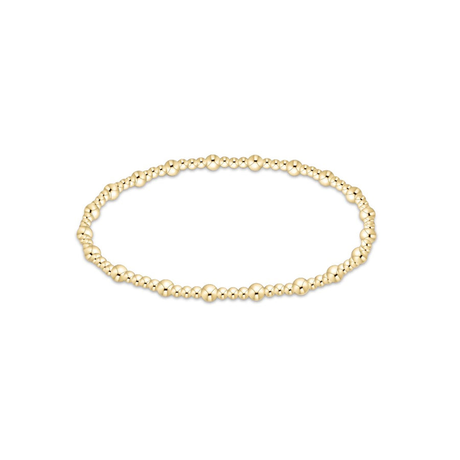 A delicate gold beaded bracelet with small, polished spherical beads linked together in a circular shape, displayed on a clean white background.