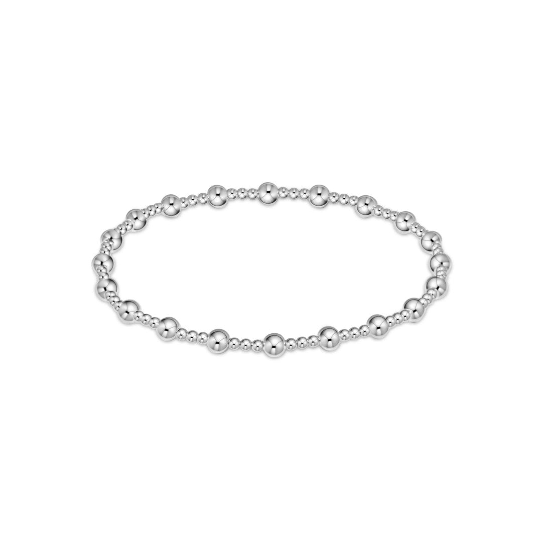 A silver beaded stretch bracelet with alternating smooth and textured spherical beads, displayed on a clean white background.