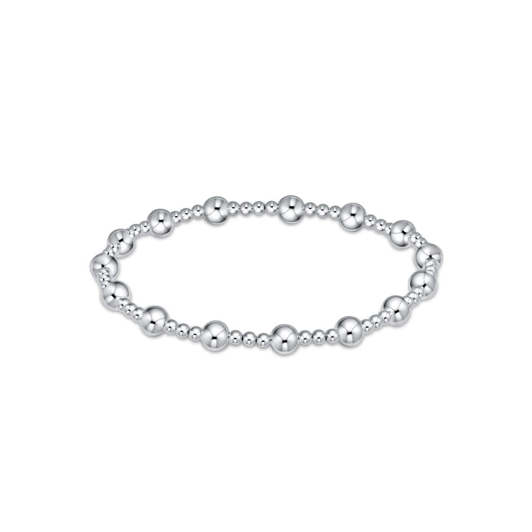 A silver beaded stretch bracelet with alternating polished and textured round beads, displayed on a clean white background.