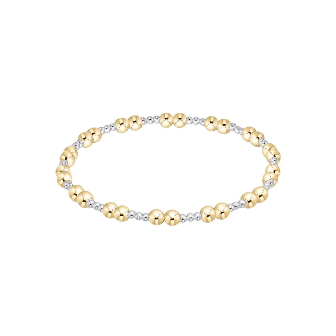 A two-tone beaded stretch bracelet featuring polished yellow gold and silver-toned beads, displayed on a clean white background.