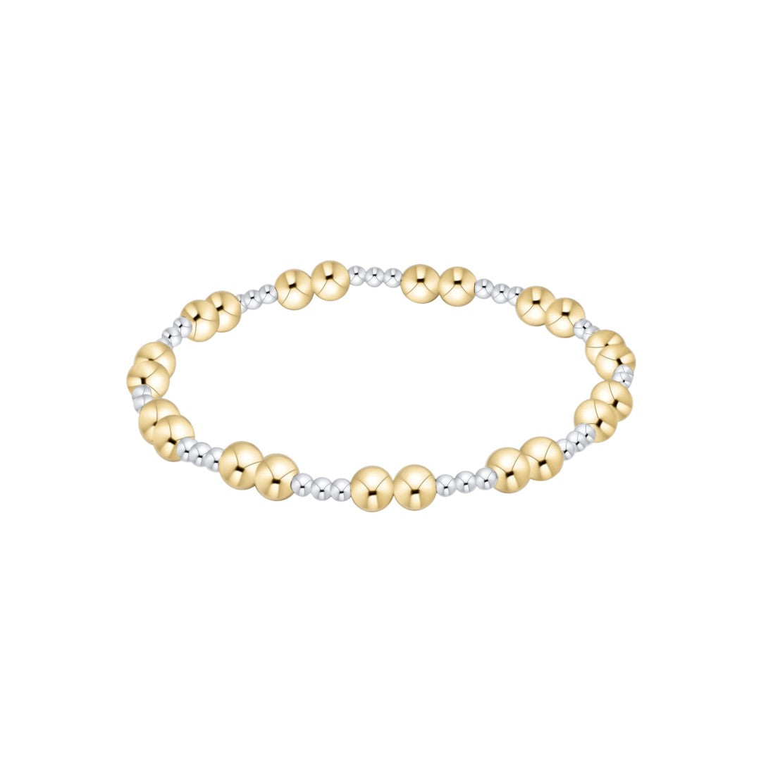 A two-tone beaded stretch bracelet featuring large polished gold beads alternating with smaller silver-toned textured beads, shown on a plain white background.