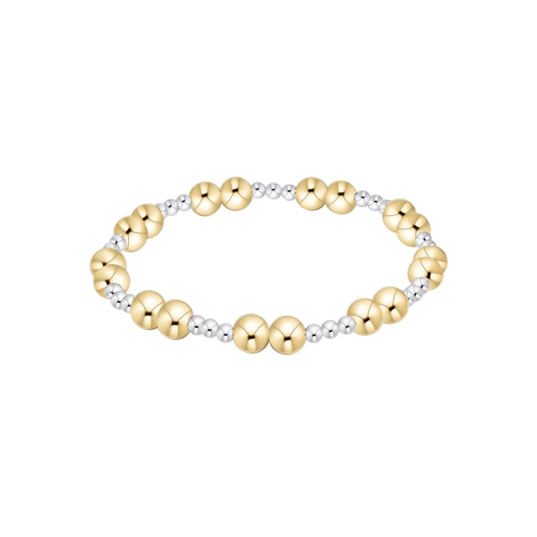 A beaded stretch bracelet featuring alternating polished yellow gold and silver metallic beads, displayed on a clean white background.