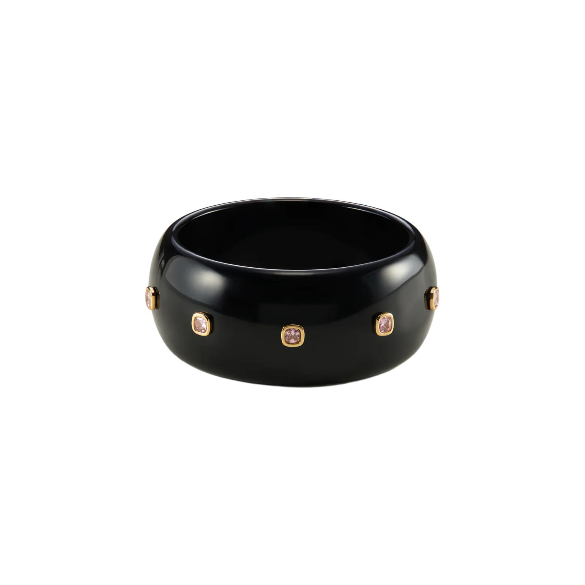A glossy black ceramic bangle bracelet with five small gold-toned oval bezel-set stones, shown on a plain white background.