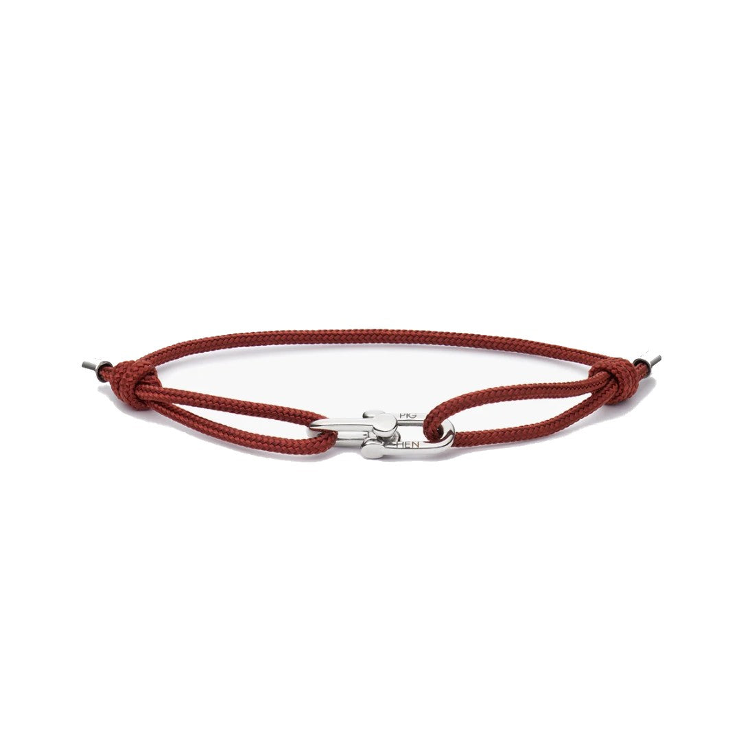 A red braided cord bracelet with a silver-toned metal clasp, displayed on a clean white background.