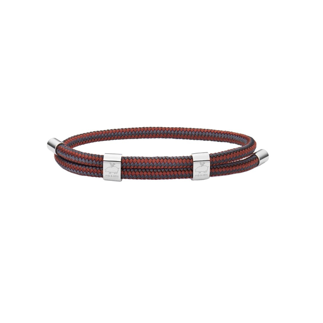 Red and gray rope bracelet with silver hardware on white background