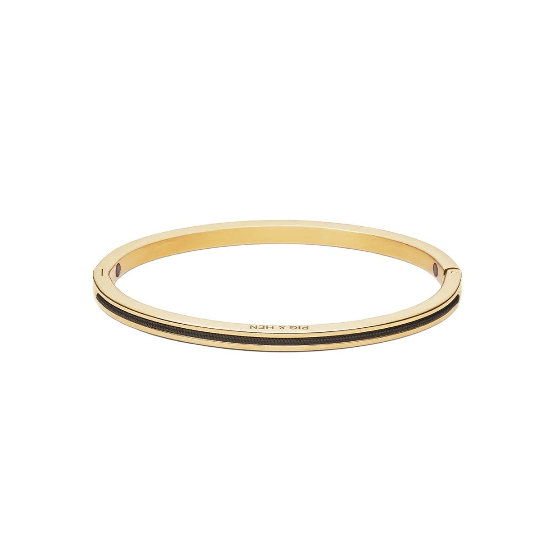 A gold-plated bangle bracelet with a double black stripe detail and 'PIG & HEN' engraved on the front, shown on a plain white background.