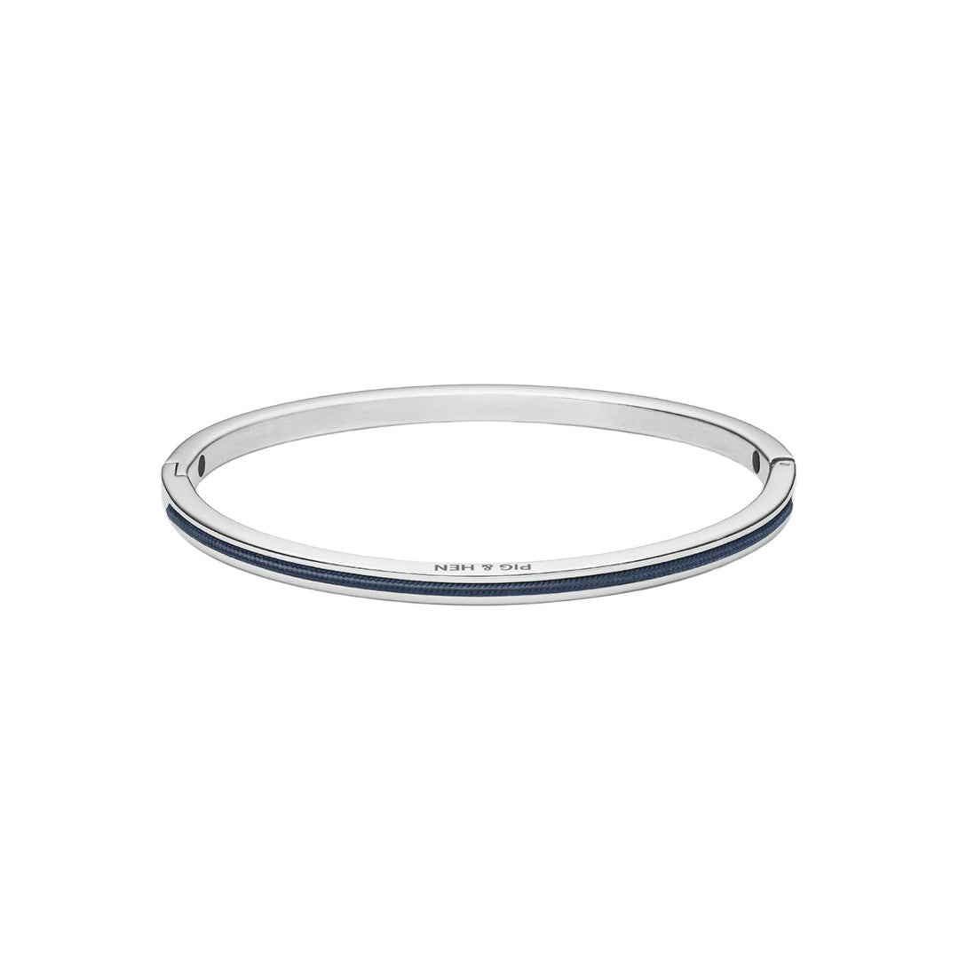 A slim silver-toned bangle bracelet with a double inlay of dark blue stones, featuring the brand name 'PIG & HEN' engraved on the front, set against a plain white background.