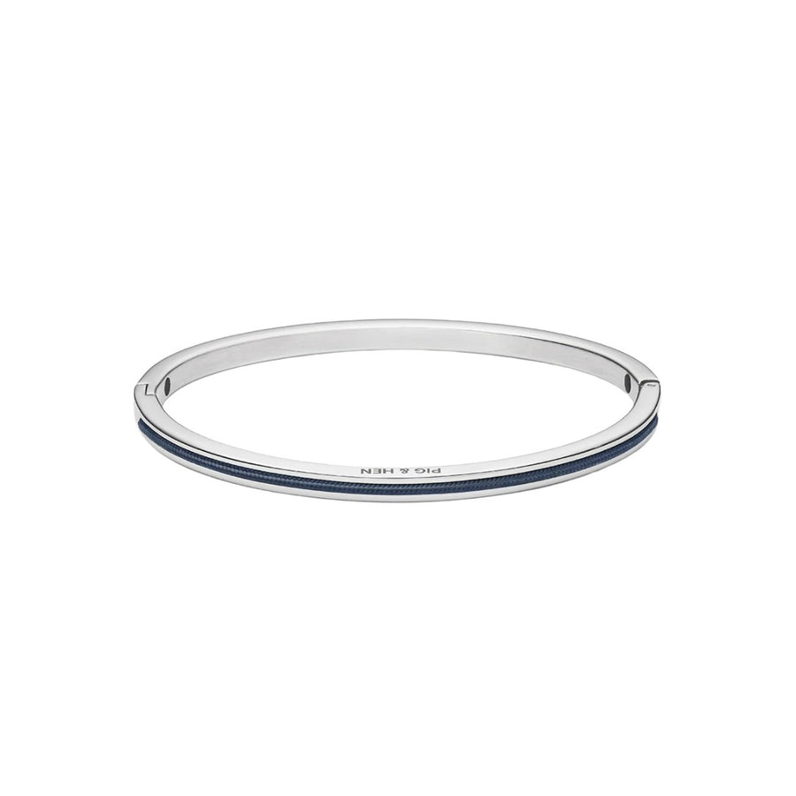 A slim silver-toned bangle bracelet with a double inlay of dark blue stones, featuring the brand name 'PIG & HEN' engraved on the front, set against a plain white background.