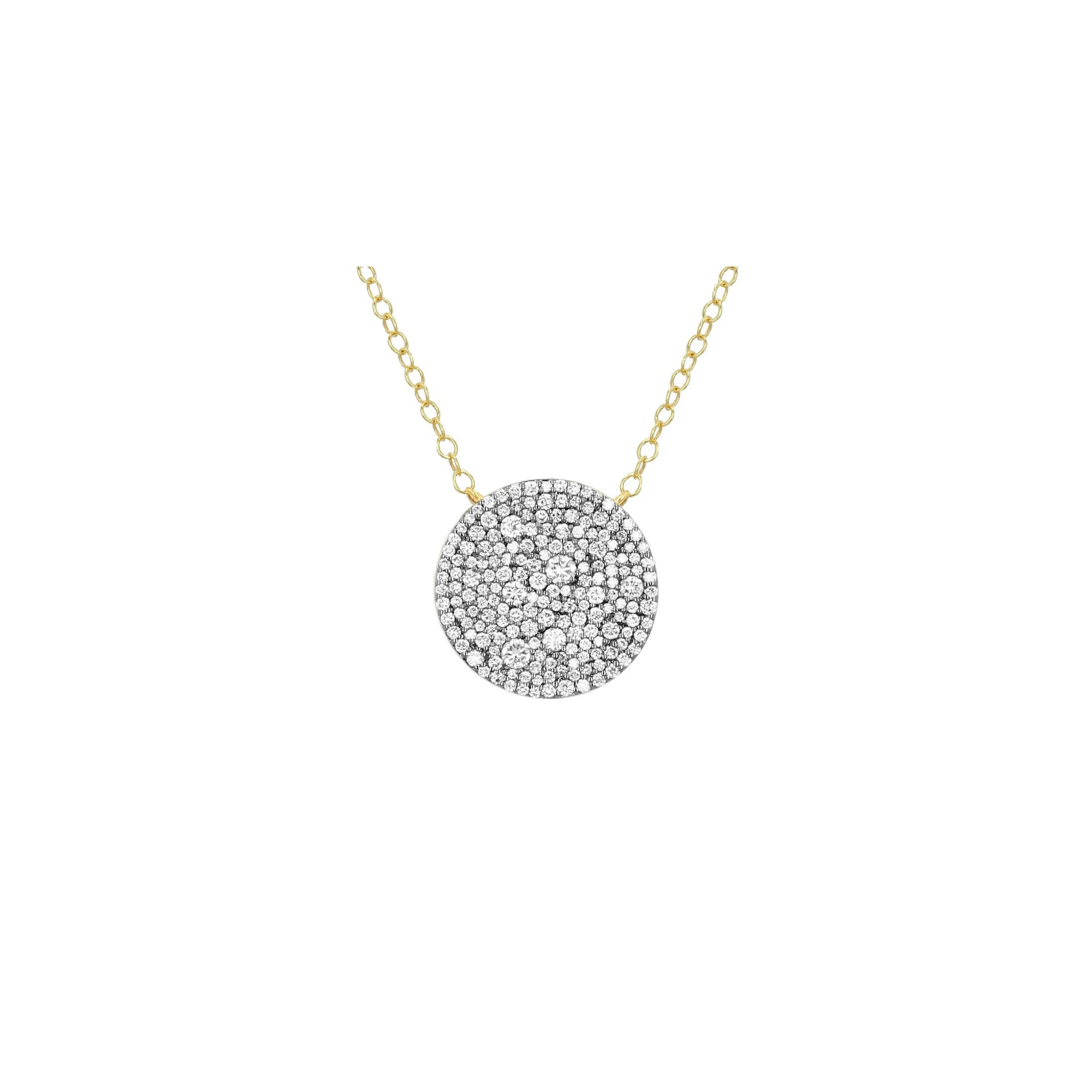 A gold pendant shaped with a dark silver center embellished with small clear pavé stones, centered on a light cream background.