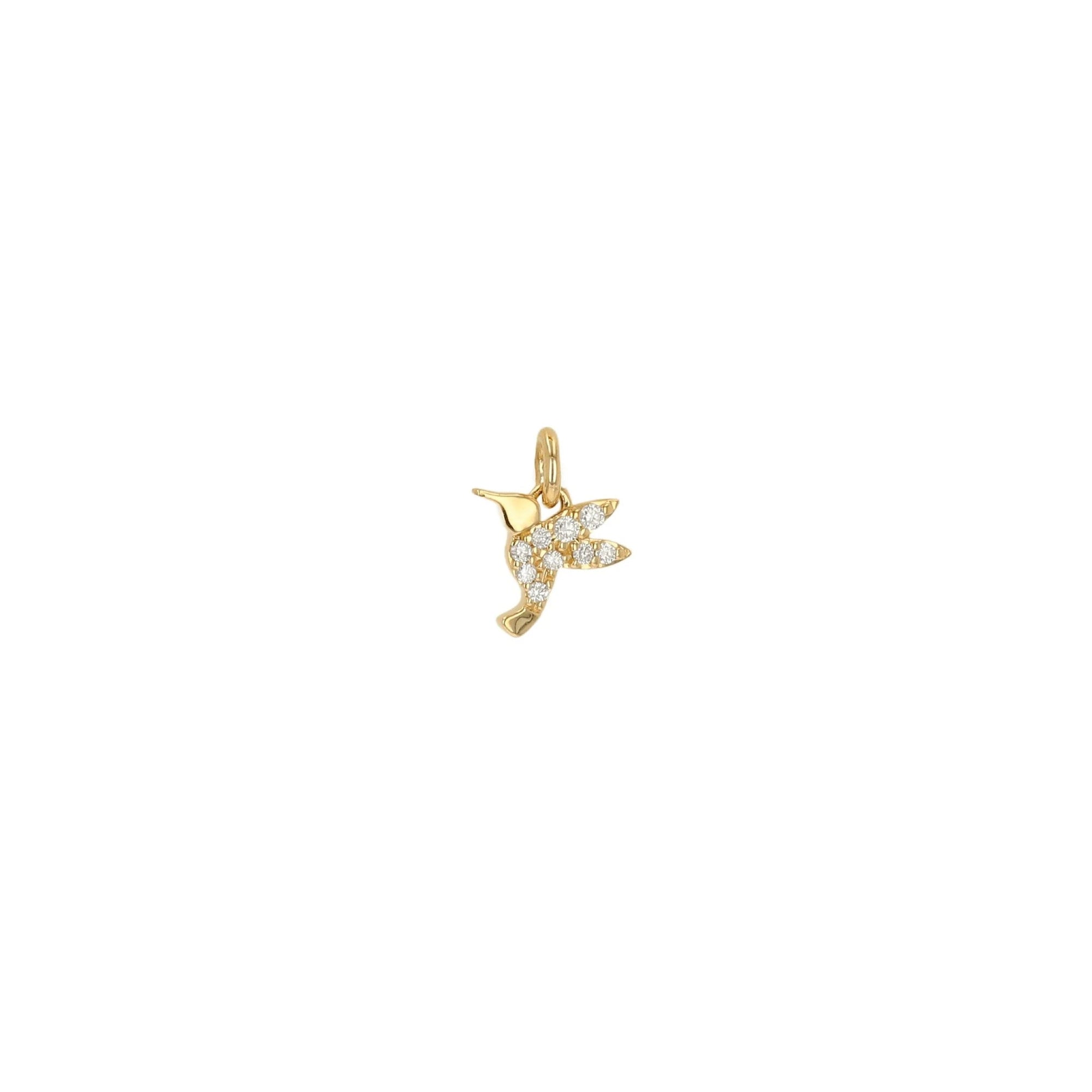 A small gold bird charm, possibly a hummingbird, decorated with pavé-set clear stones, shown on a plain white background.