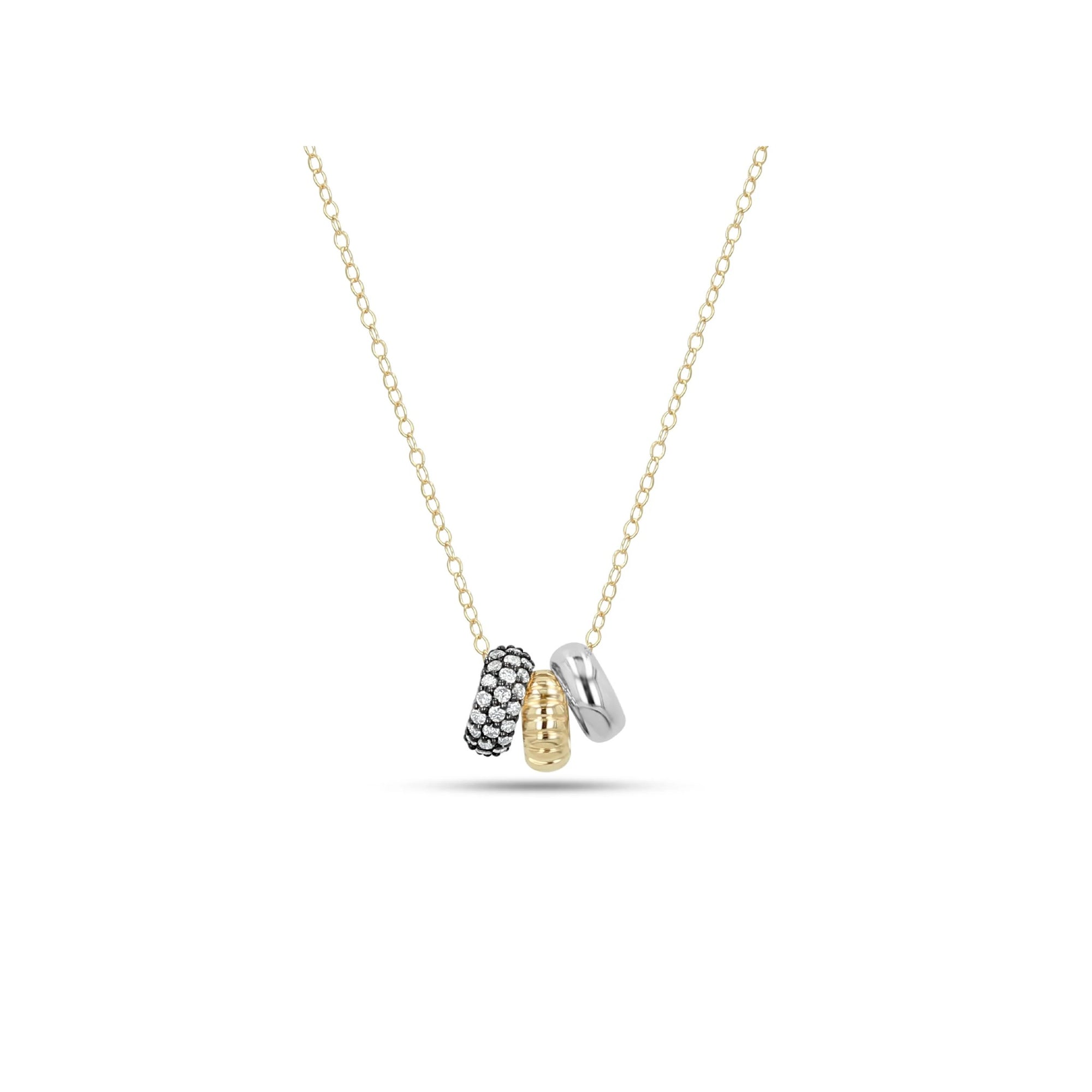 A delicate gold chain necklace featuring a pendant with three interlocking textured cylindrical charms in black, yellow gold, and silver, displayed against a solid white background.