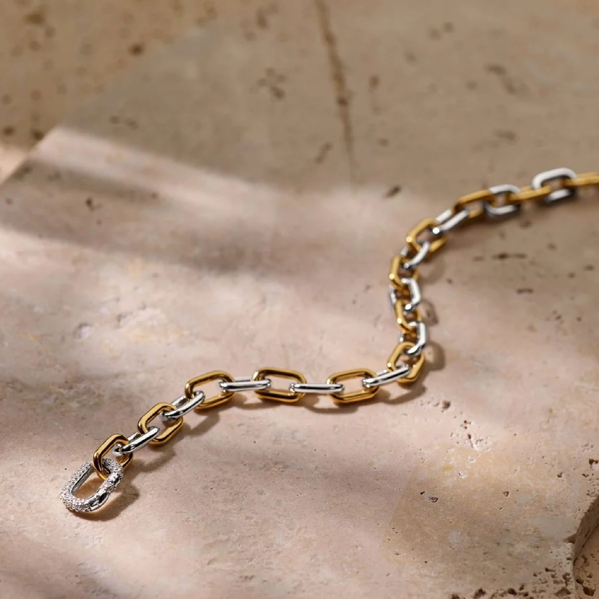 Close-up of Ti Sento chain bracelet links, two-tone silver and gold detail